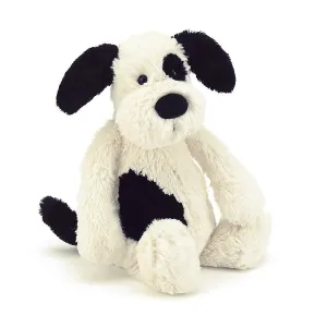BASHFUL BLACK AND CREAM PUPPY